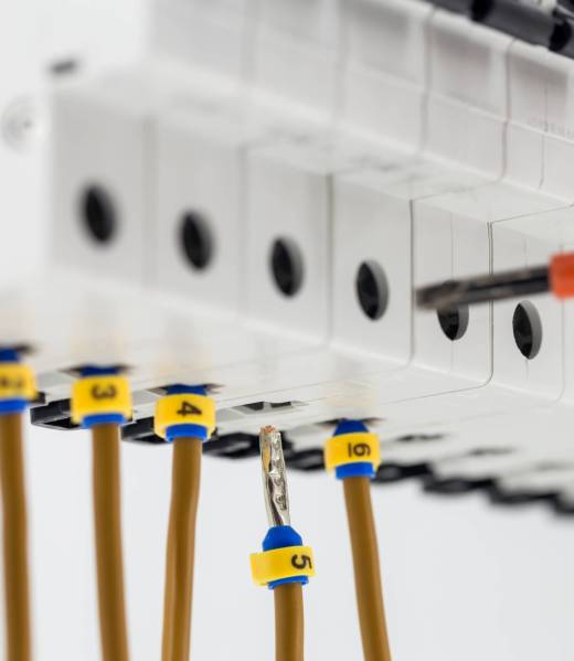 electric machines, switches, isolated on white background electric machines, switches, isolated on white background, close-up, connect marker cable to a device with a red screwdriver